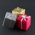 trzy kolorowe pudełka z prezentami